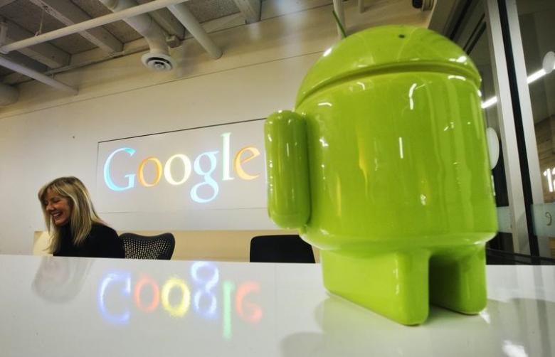 a google android figurine sits on the welcome desk as employee tracy mcneilly smiles at the new google office in toronto november 13 2012 photo reuters