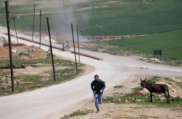 a syrian medic runs for cover during the air strikes which hit a hospital in khan sheikhun a rebel held town in the northwestern syrian idlib province on april 4 2017 photo afp a syrian medic runs for cover during the air strikes which hit a hospital in khan sheikhun a rebel held town in the northwestern syrian idlib province on april 4 2017 photo afp