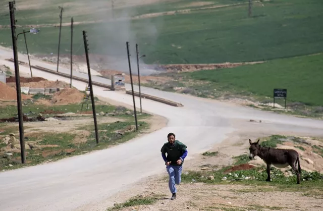 a syrian medic runs for cover during the air strikes which hit a hospital in khan sheikhun a rebel held town in the northwestern syrian idlib province on april 4 2017 photo afp a syrian medic runs for cover during the air strikes which hit a hospital in khan sheikhun a rebel held town in the northwestern syrian idlib province on april 4 2017 photo afp