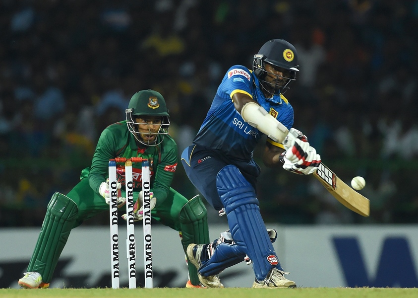 sri lankan cricketer kusal perera plays a shot as bangladesh wicketkeeper mushfiqur rahim l looks on during the first t20 international cricket match between sri lanka and bangladesh at the r premadasa stadium in colombo on april 4 2017 photo afp