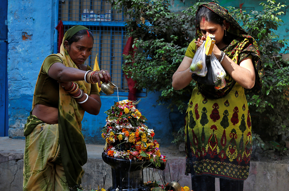 a hindu devotee pours milk over a shivling a symbol of lord shiva outside a temple in kolkata india photo reuters