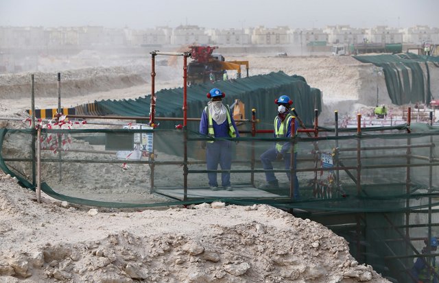 foreign laborers work at the construction site of the al wakrah football stadium one of the qatar 039 s 2022 world cup stadiums photo afp