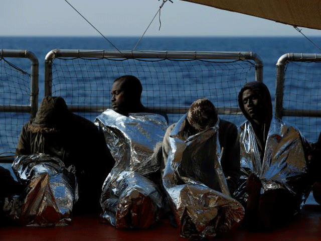 exhausted migrants rest on the malta based ngo migrant offshore aid station moas ship phoenix after being rescued photo reuters