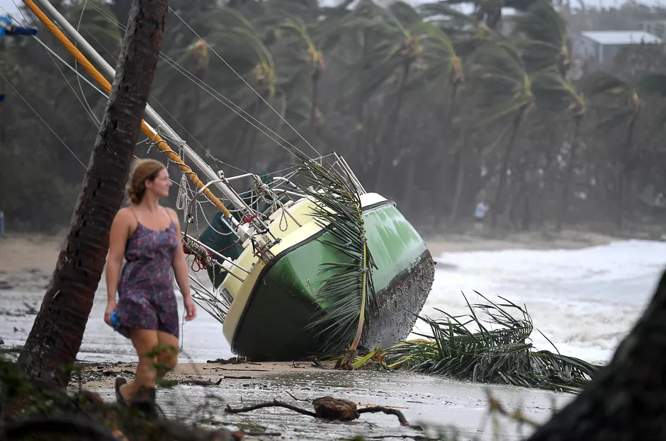 a woman walks past a yacht that was washed ashore after cyclone debbie hit the northern queensland town of airlie beach located south of townsville in australia photo reuters a woman walks past a yacht that was washed ashore after cyclone debbie hit the northern queensland town of airlie beach located south of townsville in australia photo reuters