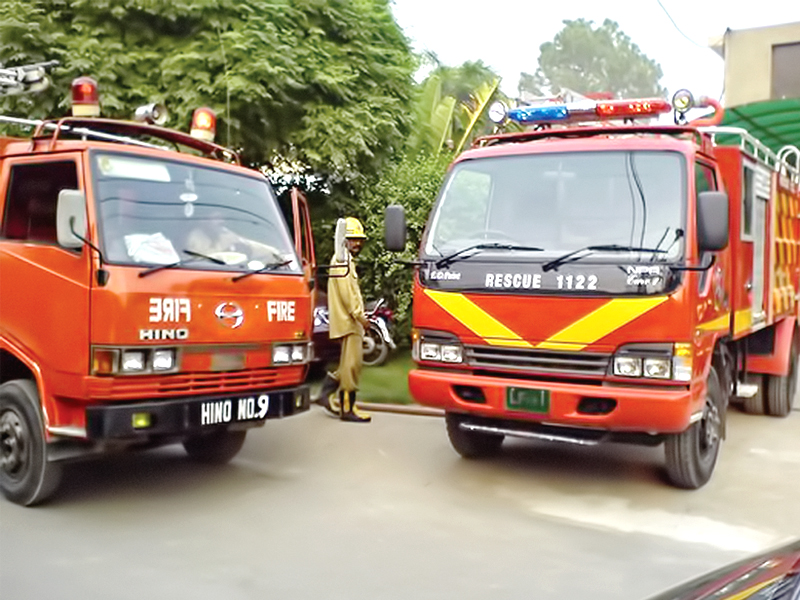 rescue 1122 vans being used to hose down a construction factory photo express