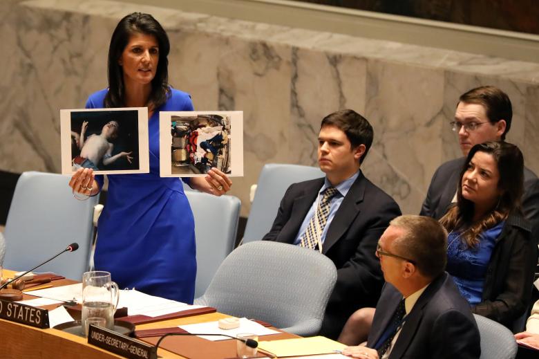 us ambassador to the united nations nikki haley holds photographs of victims during a meeting at the united nations security council on syria at the united nations headquarters in new york photo reuters