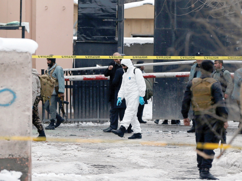 afghan policemen keep watch at the site of a bomb blast in kabul photo reuters