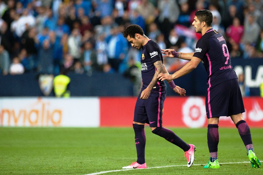 neymar was booked in the first half for delaying a malaga free kick by tying his shoelaces in front of the ball photo afp