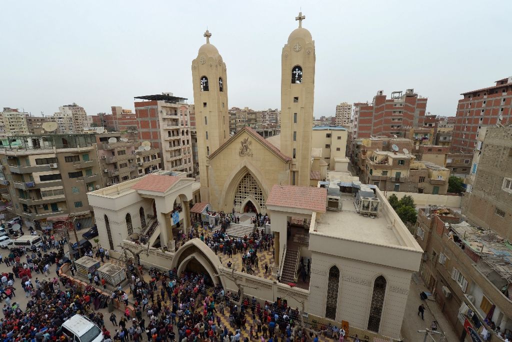 people gather outside the mar girgis coptic church in the nile delta city of tanta north of cairo after a bomb blast struck worshippers gathering to celebrate palm sunday on april 9 2017 photo afp