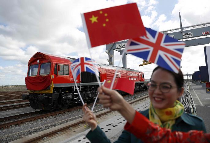 chinese women wave flags at the official ceremony to mark the departure of the first uk to china export train laden with containers of british goods from the dp world london gateway stanford le hope britain april 10 2017 photo reuters