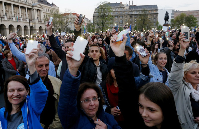 people light with their mobile phones as they protest against the bill that would undermine central european university a liberal graduate school of social sciences founded by u s financier george soros in budapest hungary april 9 2017 photo reuters