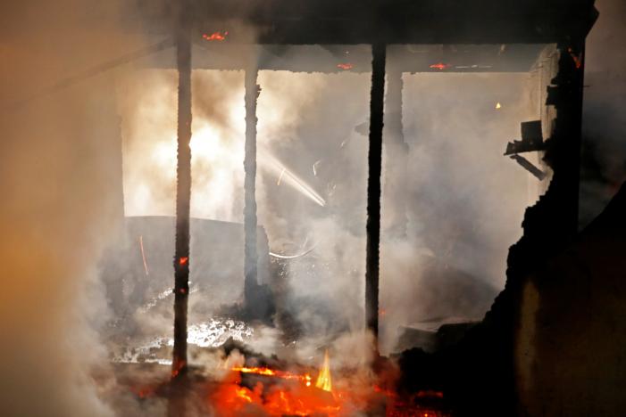 firefighters extinguish shelters during a big fire which destroyed many wood houses at a camp for migrants in grande synthe near dunkirk france april 11 2017 photo reuters