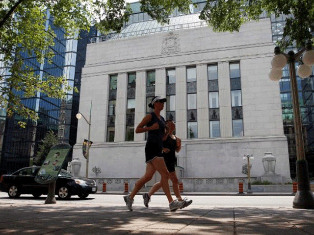 joggers run past the bank of canada building in ottawa july 17 2012 photo reuters