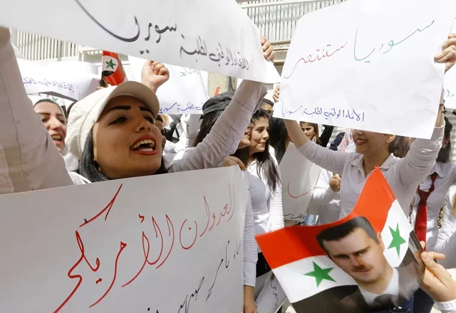 syrian women from the student union take part in a demonstration outside the united nation 039 s un office in the capital damascus on april 11 2017 in support of their country 039 s president bashar al assad the writing in arabic reads 039 039 syria will win 039 039 photo afp syrian women from the student union take part in a demonstration outside the united nation 039 s un office in the capital damascus on april 11 2017 in support of their country 039 s president bashar al assad the writing in arabic reads 039 039 syria will win 039 039 photo afp