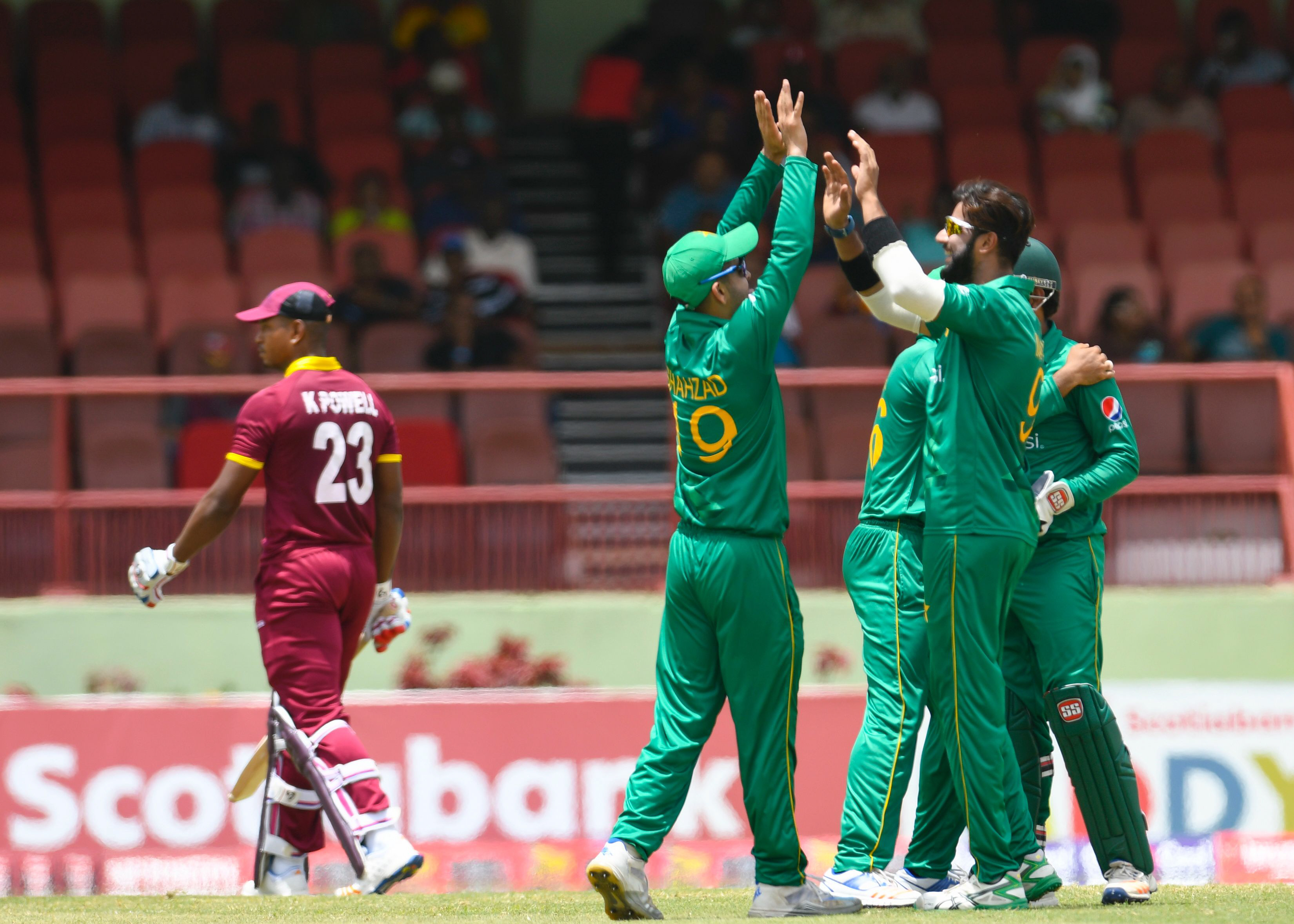 ahmed shehzad and imad wasim celebrate the dismissal of kieran powell during the final odi between west indies and pakistan at guyana national stadium providence photo afp