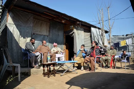 this photograph taken on february 12 2017 shows elderly indian kashmiri muhammad ashraf 2l flanked by his son muhammad asghar l as he meets with his childhoood friend muhammad sharif r upon his arrival at a refugee camp on the outskirts of muzaffarabad photo afp this photograph taken on february 12 2017 shows elderly indian kashmiri muhammad ashraf 2l flanked by his son muhammad asghar l as he meets with his childhoood friend muhammad sharif r upon his arrival at a refugee camp on the outskirts of muzaffarabad photo afp
