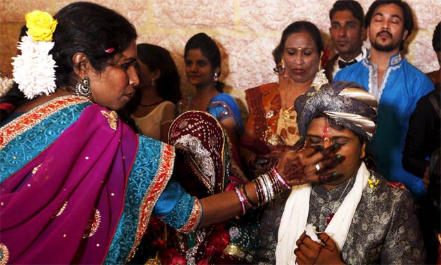 a groom receives a dot on his forehead with sindoor during a mass marriage ceremony photo reuters