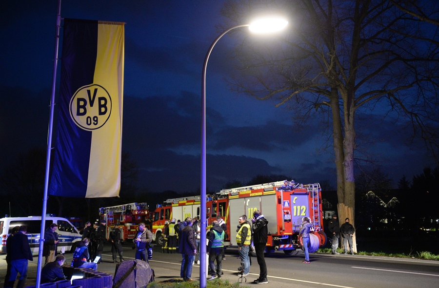 police and firefighhters are seen near the site wher borussia dortmund 039 s bus was damaged by an explosion some 10km away from the stadium prior to the uefa champions league 1st leg quarter final football match bvb borussia dortmund v monaco in dortmund western germany on april 11 2017 photo afp
