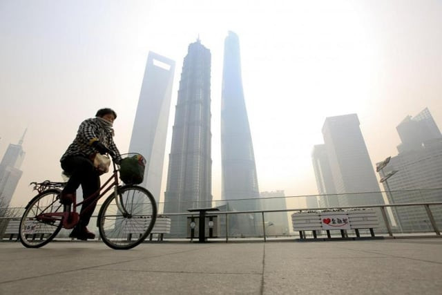a woman covers her nose and mouth with her scarf amid heavy haze as she rides a bicycle at the pudong financial area in shanghai photo reuters a woman covers her nose and mouth with her scarf amid heavy haze as she rides a bicycle at the pudong financial area in shanghai photo reuters