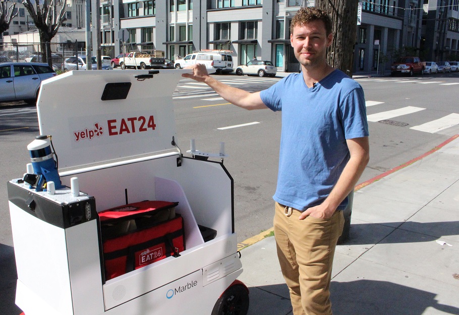 marble co founder and chief matthew delaney prepares a happy ground delivery robot to head off with a load outside the startup 039 s headquarters in san francisco california on march 29 2017 san francisco startup marble on april 12 2017 began giving its home town a taste of restaurant orders delivered by robot confident that appetite for such service will grow around the world marble partnered with take away meal ordering mobile application yelp eat24 to put its boxy wheeled robots to work handling local deliveries for some restaurants in the mission and portrero hill districts of san francisco photo afp