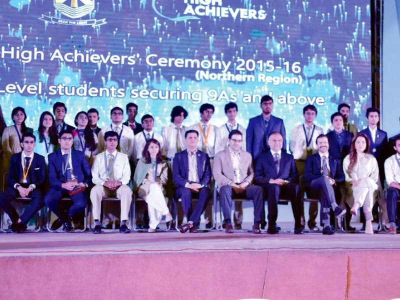 a group photo of high achieving bss students with planning minister ahsan iqbal photo express