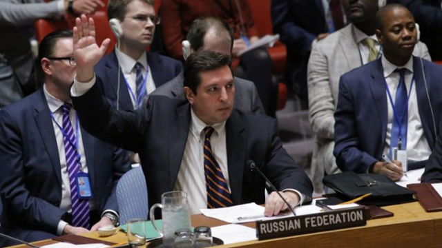 russian deputy permanent representative to the united nations vladimir safronkov holds up his hand as he votes against a draft resolution that condemned the reported use of chemical weapons in syria during a meeting at the un headquarters in new york april 12 2017 photo afp