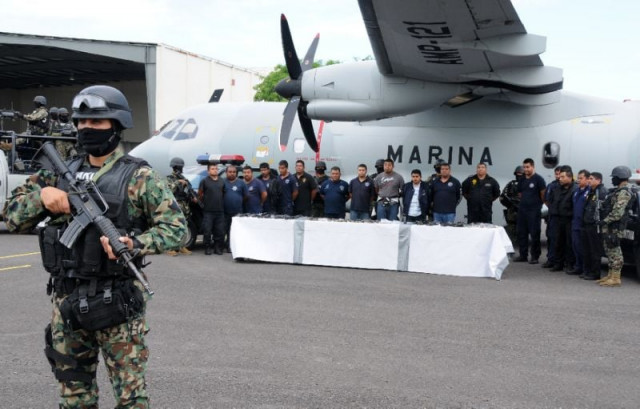 mexican marines escort a group of alleged municipal policemen working for the zeta cartel five members of the same cartel and nine escaped inmates in veracruz photo afp