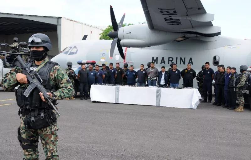mexican marines escort a group of alleged municipal policemen working for the zeta cartel five members of the same cartel and nine escaped inmates in veracruz photo afp mexican marines escort a group of alleged municipal policemen working for the zeta cartel five members of the same cartel and nine escaped inmates in veracruz photo afp
