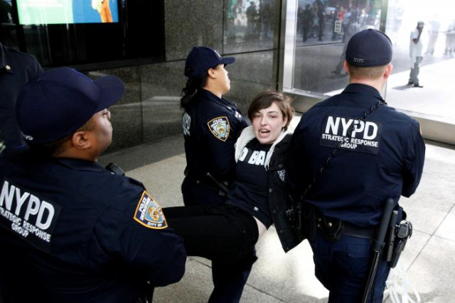 new york city police officers nypd carry a protestor after making arrests for demonstrating in trump tower in new york city u s april 13 2017 photo reuters new york city police officers nypd carry a protestor after making arrests for demonstrating in trump tower in new york city u s april 13 2017 photo reuters