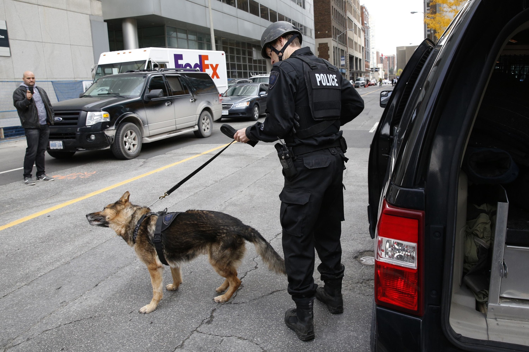 a ottawa police officer prepares a service dog following shooting incidents in downtown ottawa october 22 2014 a canadian soldier was shot at the national war memorial in downtown ottawa and a gunman was shot and killed in a nearby parliament building media and witnesses reported photo reuters