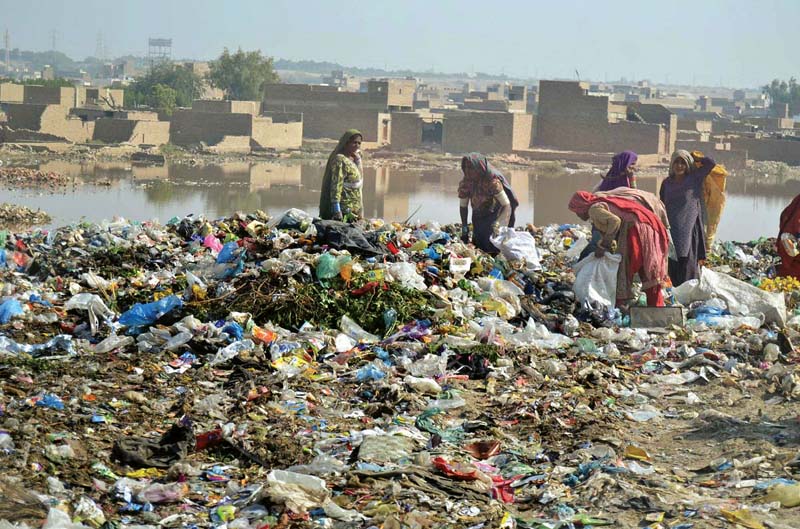 women look for valuables in a garbage dump at phuleli canal photo file