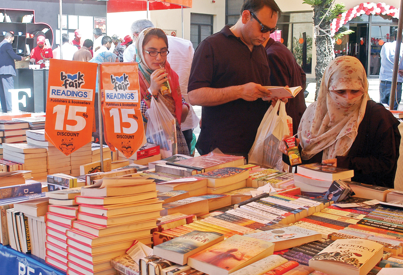 people browse through books displayed on a stall at ilf photo waseem nazir express