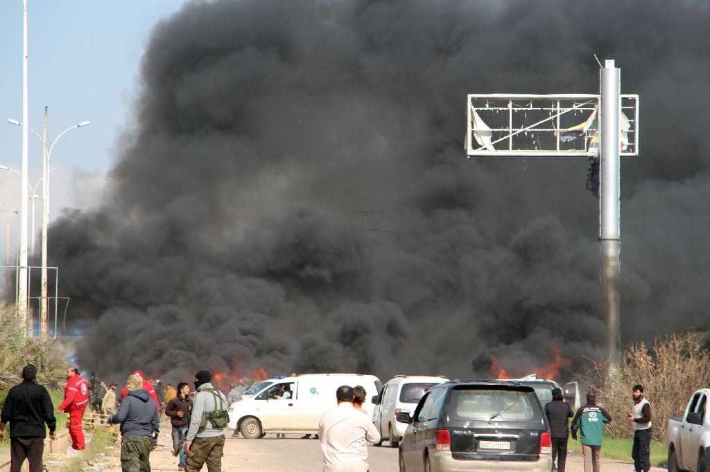 smoke billows from the site of a suicide car bombing in rashidin west of aleppo that targeted buses carrying syrian evacuees on april 15 2017 photo afp