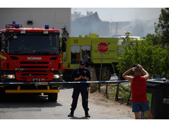 a man takes pictures near the site where a small airplane crashed near a supermarket in a residential area outside lisbon portugal april 17 2017 photo reuters