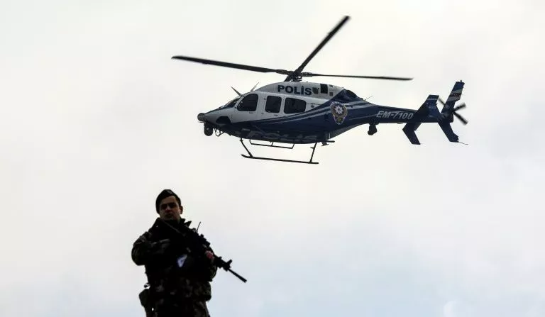 a police helicopter flies over a member of security forces near a courthouse in mugla western turkey on february 20 2017 photo afp a police helicopter flies over a member of security forces near a courthouse in mugla western turkey on february 20 2017 photo afp