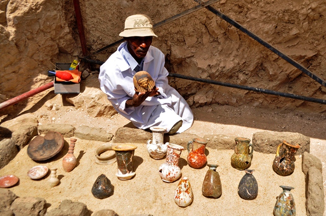 an archaeologists shows artifacts discovered in a 3 500 year old tomb in the draa abul nagaa necropolis near the southern egyptian city of luxor on april 18 2017 photo afp