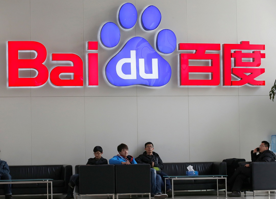 people sit in front of the company logo of baidu at its headquarters in beijing photo reuters