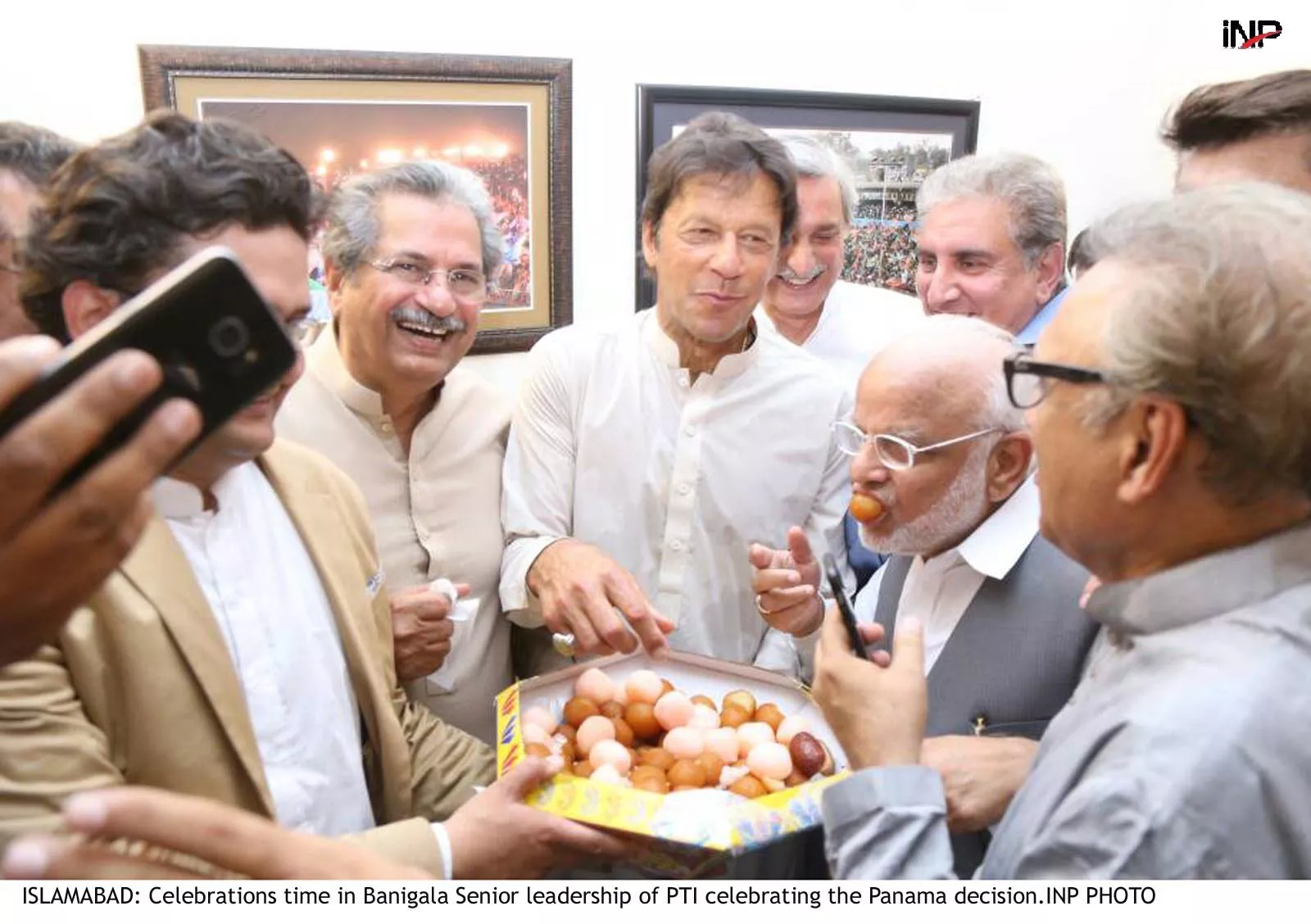 pti leaders exchange sweets after the sc announced its judgemnet photo inp pti leaders exchange sweets after the sc announced its judgemnet photo inp