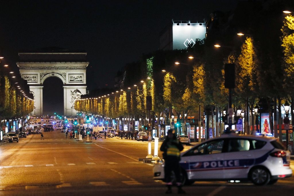 police block access to the champs elysees in paris after a shooting left one officer dead and two wounded police block access to the champs elysees in paris after a shooting left one officer dead and two wounded photo afp