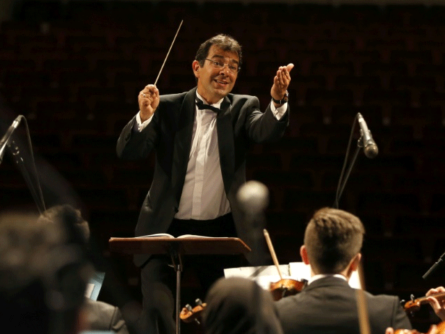 french iranian conductor pejman memarzadeh leads the tehran symphony orchestra at vahdat hall in tehran on april 19 2017 photo afp