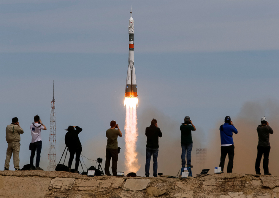 photographers take pictures as the soyuz ms 04 spacecraft carrying the crew of jack fischer of the us and fyodor yurchikhin of russia blasts off to the international space station iss from the launchpad at the baikonur cosmodrome kazakhstan photo reuters