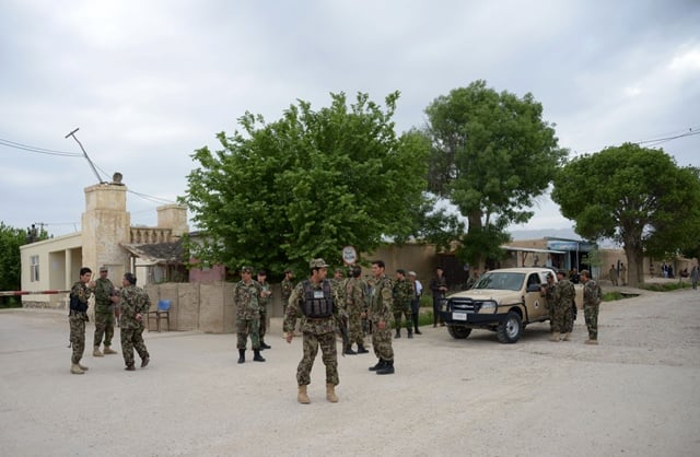 afghan security personnel keep watch near the site of the attack on an army compound in dihdadi district of balkh province photo afp