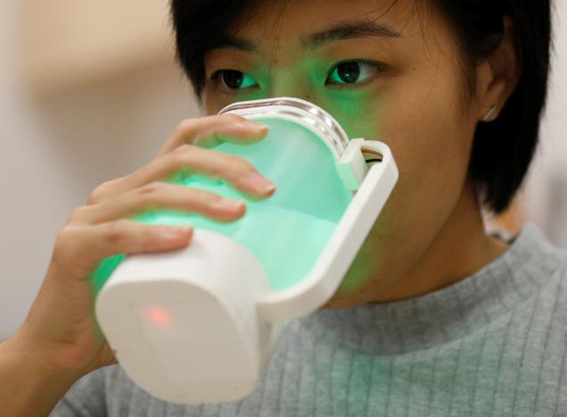 an nus student tastes a virtual lemonade simulator which uses electrodes to mimic the flavour and led lights to imitate the color of real lemonade photo reuters