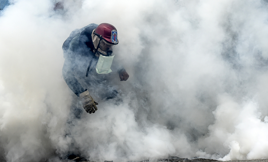 a demonstrator clashes with the riot police during a protest against venezuelan president nicolas maduro in caracas photo afp