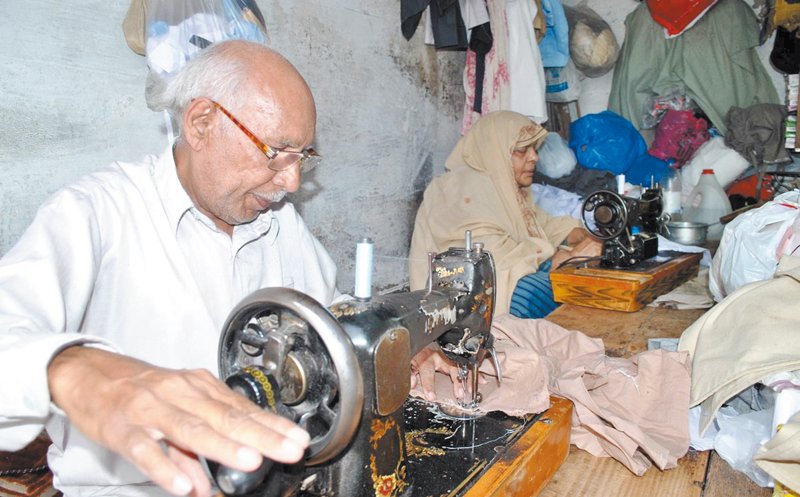 tailors sulman and shakeela bibi busy in their work at the shop in rawalpindi s lanada bazaar where they have been stitching clothes for the past 52 years photo online