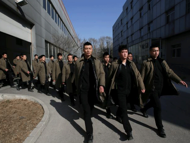 trainees from dewei security walk for a daily training session at a training camp on the outskirts of beijing china march 2 2017 photo reuters