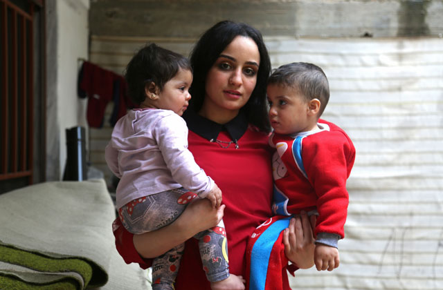 twenty three year old islam maytat from morocco poses for a photo with her children maria l and abdullah in the kurdish majority city of qamishli in northern syrian on april 13 2017 after she escaped from islamic state is group territory following three traumatic years living in the group 039 s so called 039 caliphate 039 photo afp