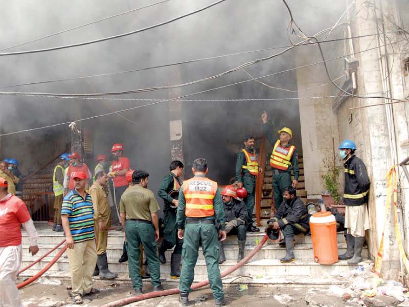 firefighters try to extinguish the flames inside muhafiz plaza photo express