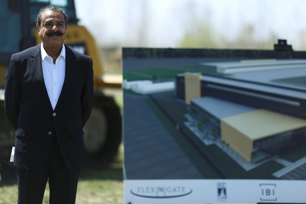 owner and businessman shahid khan stands alongside an artist 039 s rendering of the flex n gate manufacturing facility during a ground breaking ceremony at the site in the i 94 industrial park in detroit michigan us april 24 2017 photo reuters