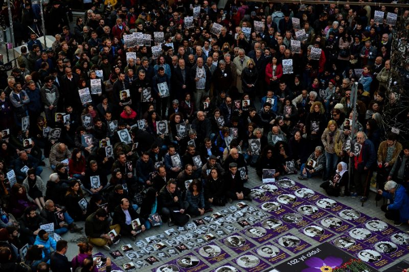 people hold the portraits of armenian intellectuals detained and deported in 1915 during a rally on the istiklal avenue in istanbul on april 24 2017 to commemorate the 102nd anniversary of the 1915 mass killing of armenians in the ottoman empire photo afp